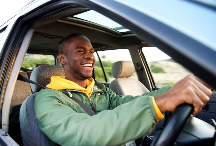 Smiling man driving car