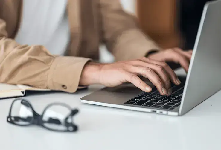 A person typing on a laptop