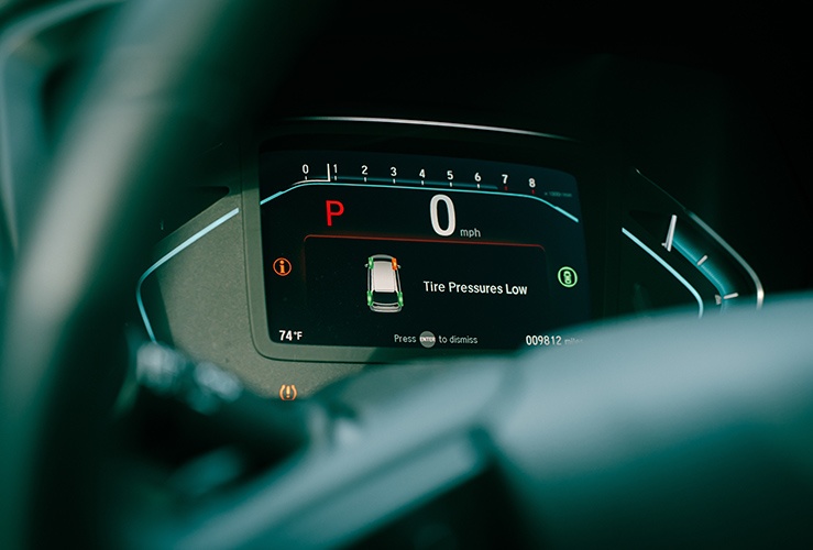 Tyre pressure low indicator showing on a car dashboard