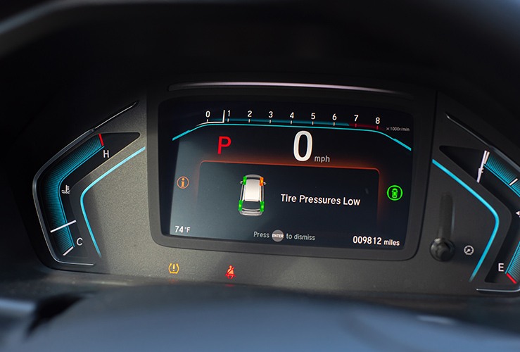 Tyre pressure monitor system showing a flat tyre on a dashboard