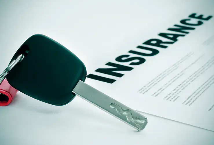A car key and car insurance document