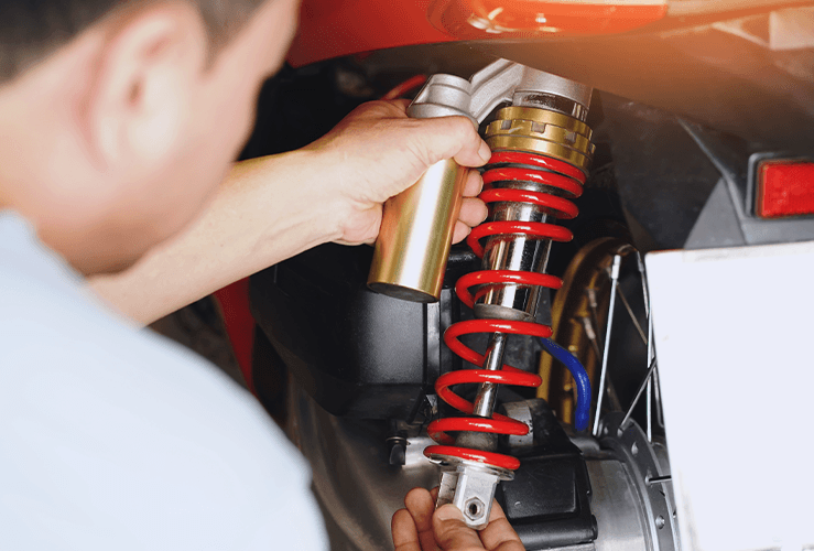 A mechanic working on a shock absorber