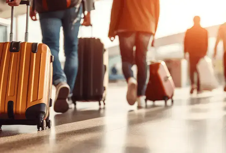 People with suitcases walking through an airport