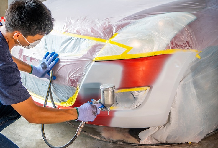 Spraying car covered in protective wrapping