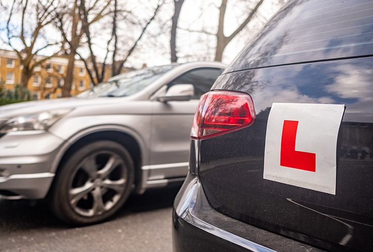 Photo of a parked car with a Learner Plate on the back