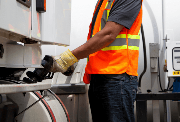 Truck driver refuelling lorry