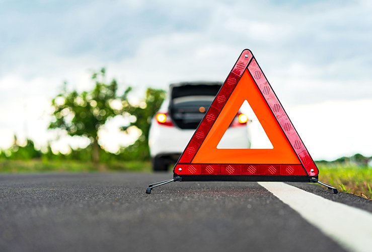 Car in front of warning triangle after breakdown