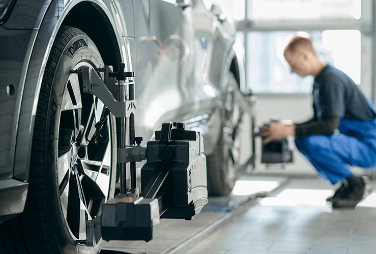 Person checking wheel alignment