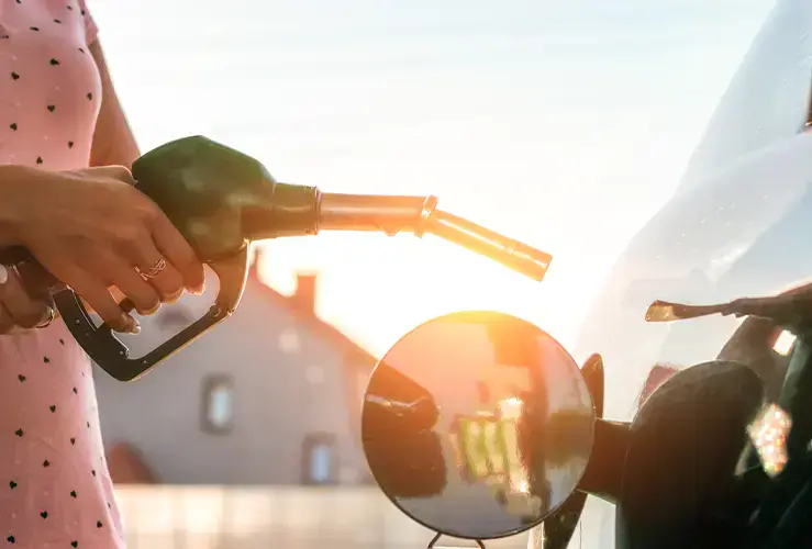 A person putting fuel in their car