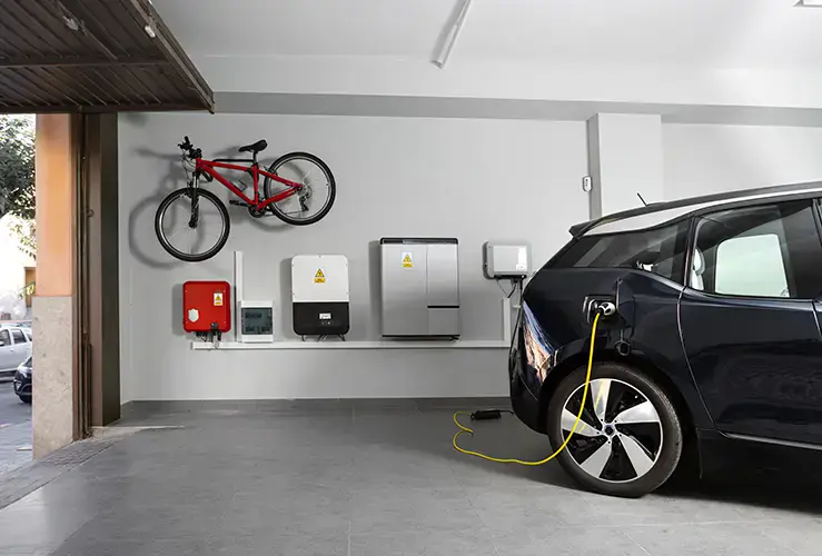 An electric car charging in a garage