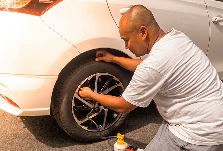 Man using a car tyre sealant kit