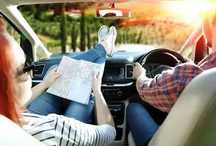 People in a car looking at a map