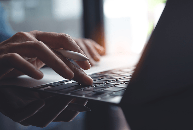 A person typing on a laptop